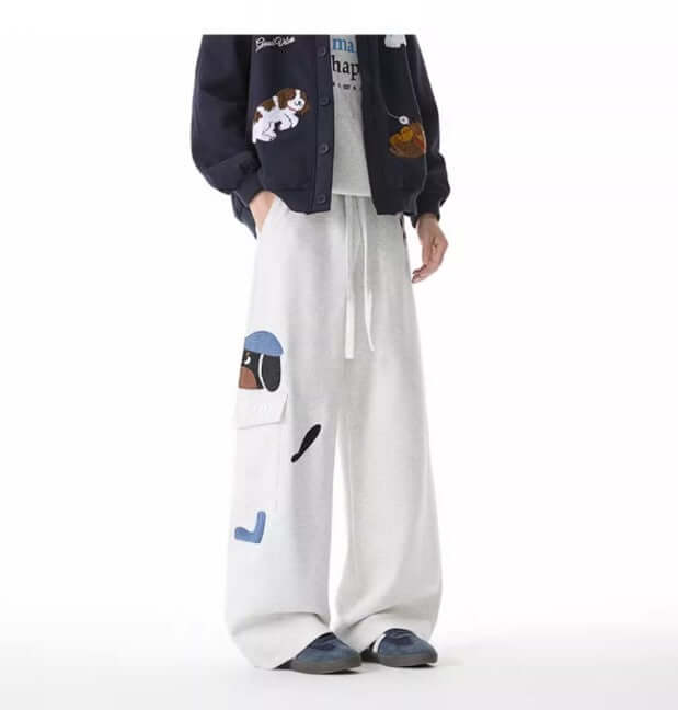 Dog Embroidered Sweatpants - Loose Fit worn with a navy jacket, showcasing playful vintage embroidery and a relaxed look.