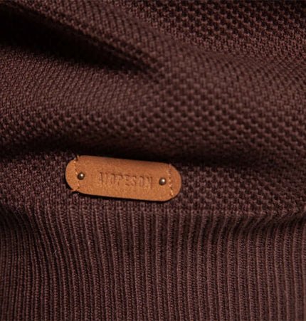 Close-up of the label on the Grozavu Stand Collar Half-Zip Knit Sweater in brown texture.