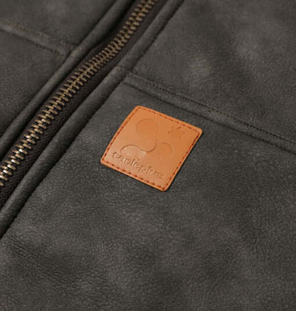 Close-up of the Thick Suede Hooded Jacket – Street Style showcasing the zipper and brand tag detail.