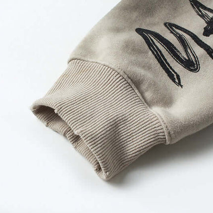 Close-up of sleeve detail on Retro Patchwork Zip Up Hoodie – Loose Fit showcasing ribbed cuff and embroidered design.