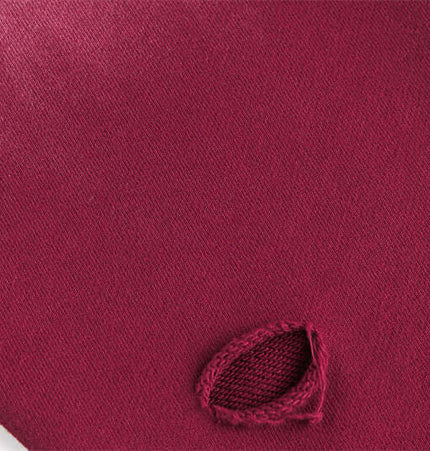 Close-up view of the Grozavu Half-Zip Printed Hoodie – Loose Fit fabric detail with a distinctive burgundy color feature.