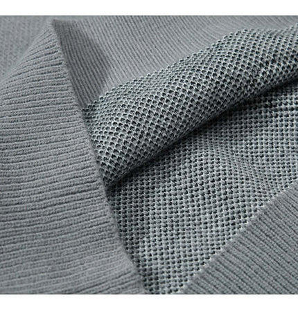 Close-up of the fabric texture of the Fringe Patchwork Knit Sweater – Loose Fit showcasing the knit details.