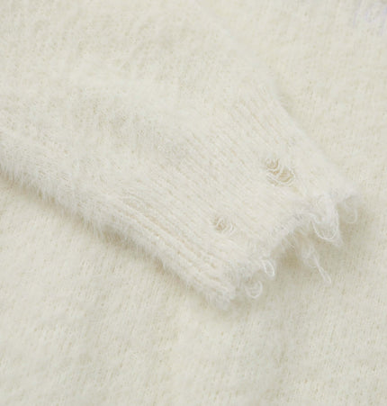 Close-up view of the sleeve of a Knit Sweater with Letter Applique showcasing soft texture and detailed stitching.