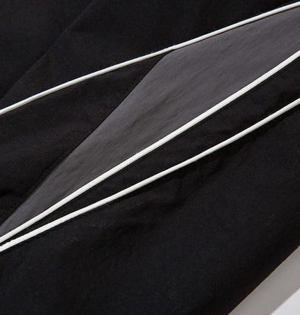 Close-up view of the fabric and patchwork detail on Outdoor Casual Retro Patchwork Pants.