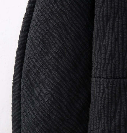 Close-up of the textured fabric on the Fur Cuff Single Breasted Jacket showcasing its elegant black design.