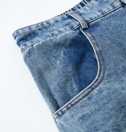 Close-up of Cartoon Patch College Denim Pants showcasing denim texture and pocket design.