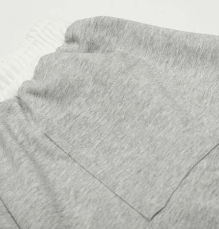 Close-up of the fabric and pocket detail on Towel Embroidery Heart Sweatpants.