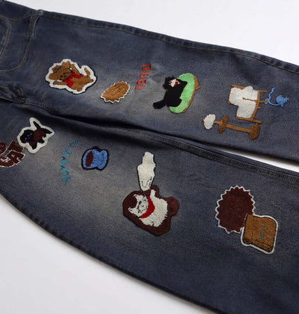 Vintage Washed Cartoon Embroidered Jeans with playful cartoon towel embroidery details on a washed denim finish.