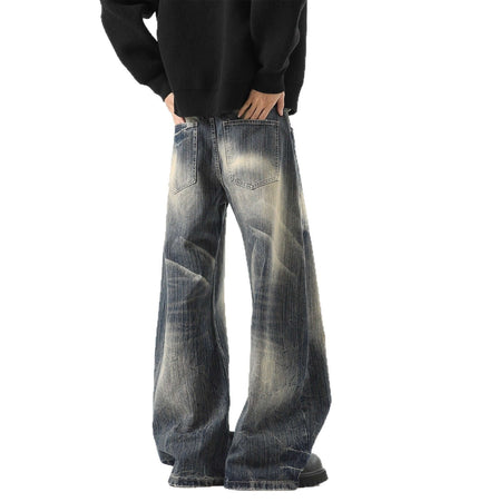 Knife-Edge Denim Trousers – Loose Fit showcased from the back, featuring wide legs and a washed distressed finish.