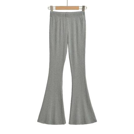 Slim Fit Low Waist Slightly Flared Pants in grey hanging on a wooden hanger.