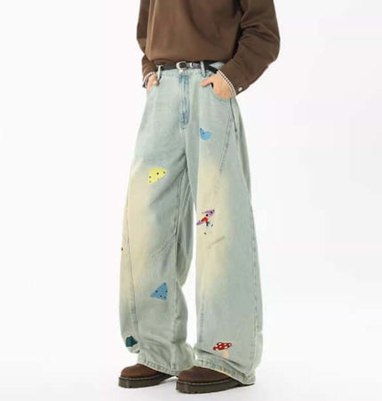 Embroidered Patchwork Denim Pants showcasing playful urban style with distinct patchwork designs and a relaxed fit.