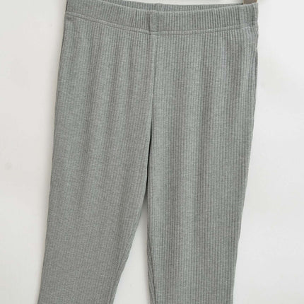 Slim Fit Low Waist Slightly Flared Pants displayed on a hanger, showcasing the sleek design and fabric texture.