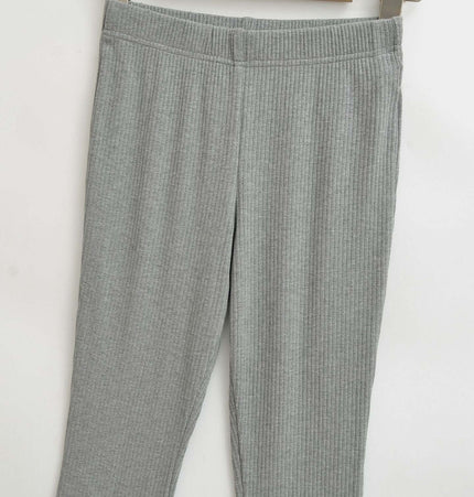 Slim Fit Low Waist Slightly Flared Pants displayed on a hanger, showcasing the sleek design and fabric texture.