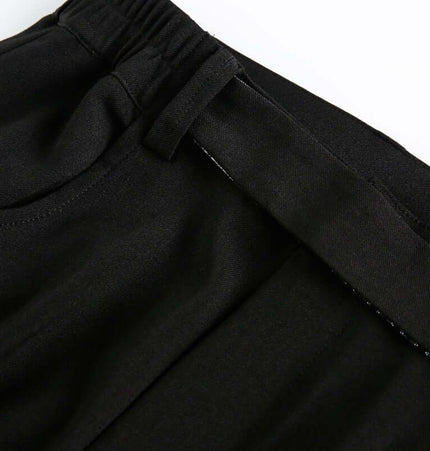 Close-up of the waistband of Wide Leg Pleated Plaid Trousers, highlighting the mid-waist drawstring closure design.