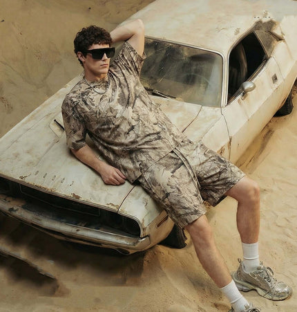 Grozavu Camouflage Drop-Shoulder TShirt – Loose Fit styled with matching shorts, relaxed look against vintage car in desert.