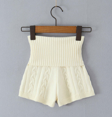 Off-Shoulder Twists Slim Knit Sweater in cream color with ribbed waistband and cable knit design, hanging on a wooden hanger.