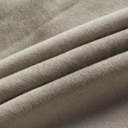 Close-up of soft, beige cotton fabric showcasing the texture and quality for Retro Patchwork Zip Up Hoodie – Loose Fit.