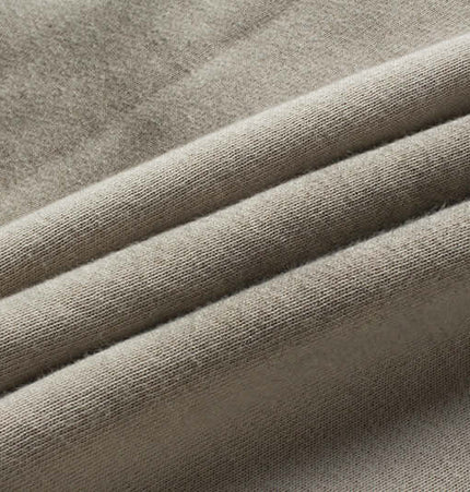 Close-up of soft, beige cotton fabric showcasing the texture and quality for Retro Patchwork Zip Up Hoodie – Loose Fit.