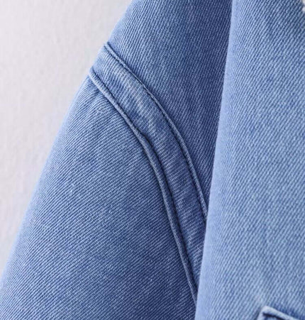Close-up of the sleeve detail on a Loose Fit Short Zip Jacket in classic blue fabric.
