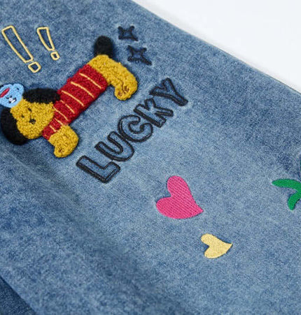 Close-up of cartoon embroidered patches on Cartoon Patch College Denim Pants, showcasing playful designs and vibrant colors.