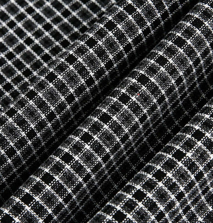 Checkered Patchwork Shirt - Loose Fit fabric close-up showing black and white checkered pattern for casual wear.