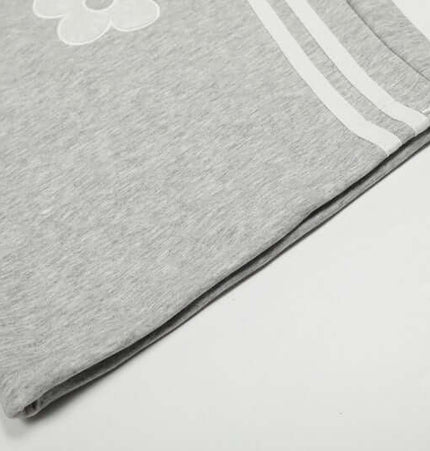 Close-up view of Towel Embroidery Heart Sweatpants showcasing the hem and decorative stripes.