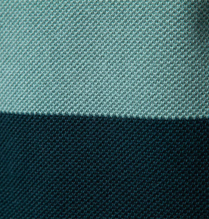 Close-up of fabric texture showcasing the color-blocked design of the Stand Collar Half-Zip Knit Sweater.
