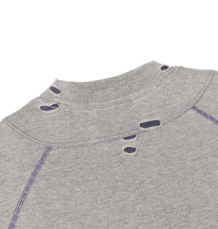 Distressed Short Sleeve TShirt – Loose Fit with intentional ripped hole detailing and raw edge design.