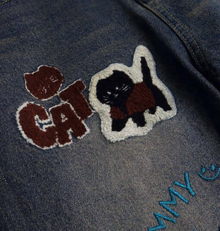 Vintage Washed Cartoon Embroidered Jeans with playful cat and cartoon towel embroidery details.