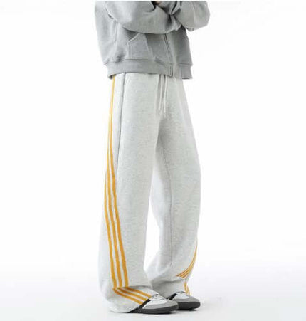 Heavyweight Three-Stripe Pants - Loose Fit paired with a grey hoodie, showcasing sporty style and comfort.