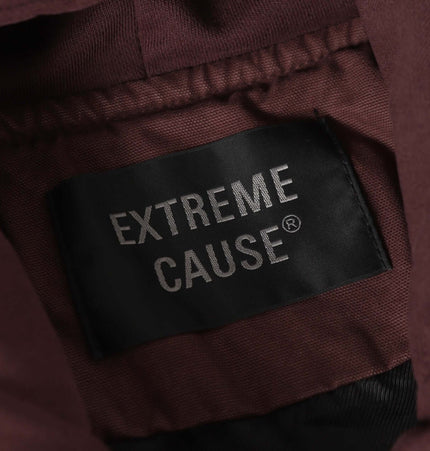 Label of Extreme Cause on a brown fabric jacket, showcasing brand detail and quality.