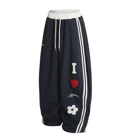 Towel Embroidery Heart Sweatpants with bold heart and flower graphics, designed for comfort and street style.