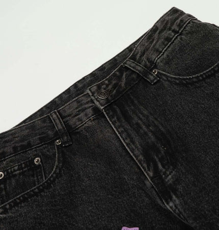 Retro Cross Flared Denim Pants – Slim Fit, detailed view of flared hem and topstitching on black denim.