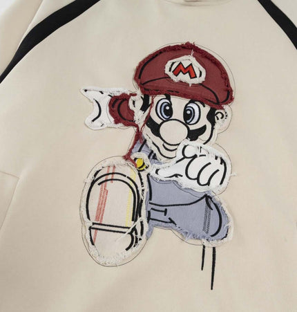 Retro Cartoon Patchwork Hoodie – Loose Fit featuring a playful cartoon character appliqué design.