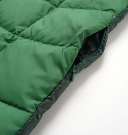 Close-up of the Color-Block Down Jacket – Loose Fit showcasing the bold green fabric and zipper detail.