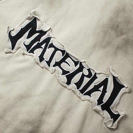Close-up view of the embroidered 'MATERIAL' lettering on the Retro Patchwork Zip Up Hoodie – Loose Fit.