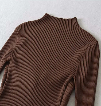 Metal Knot Hollow-Out Flare Sleeve Knit Top with ribbed texture and high neckline on a soft fabric background.