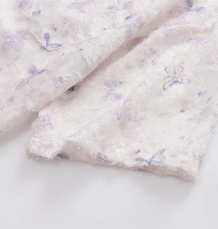 Detail of Butterfly Jacquard Printed Shirt showcasing purple floral patterns on lightweight fabric.