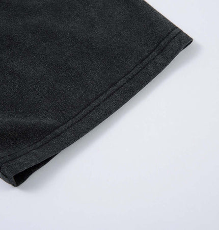 Close-up of the sleeve hem detail on the Retro Washed Badge Letter TShirt – Loose Fit.