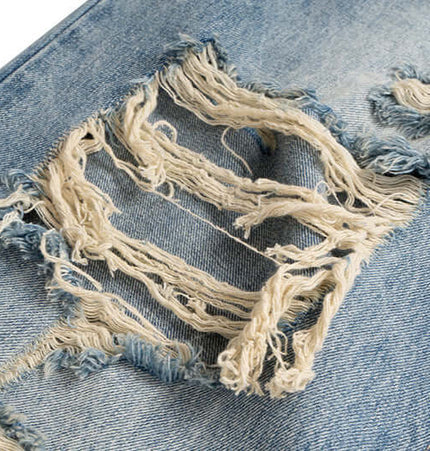 Close-up of distressed hole detail on Distressed Hole Wide-Leg Denim Pants, showcasing frayed edges and vintage texture.