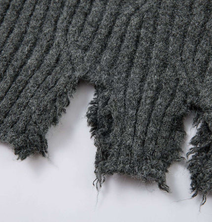Close-up detail of the ripped hem of the Ripped Hem Knit Cardigan – Loose Fit in dark gray knit fabric.