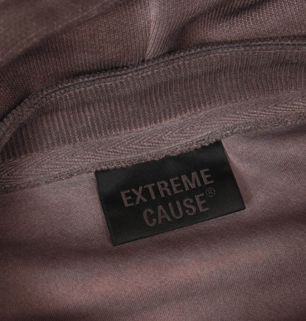 Close-up of the inner label on the Old Patchwork Hoodie – Loose Fit, showcasing the Extreme Cause brand logo.
