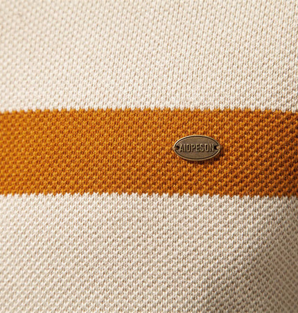 Close-up of the label on the Stand Collar Half-Zip Knit Sweater featuring color-blocked design.
