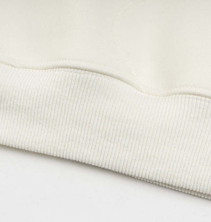 Embroidered Letter Hoodie – Loose Fit close-up of the soft ribbed hem detail showing premium quality.