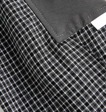 Close-up of Checkered Patchwork Shirt - Loose Fit fabric showcasing black and white checkered pattern and patchwork details.