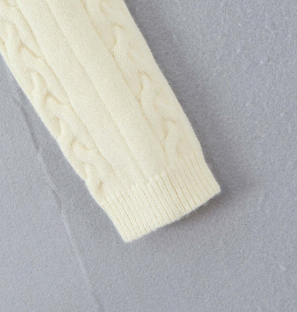 Off-Shoulder Twists Slim Knit Sweater close-up of the cream cable-knit sleeve on a textured gray background.