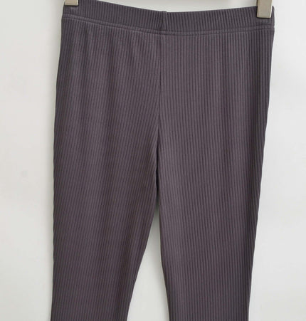 Slim Fit Low Waist Slightly Flared Pants hanging on a wooden hanger showcasing the ribbed texture.