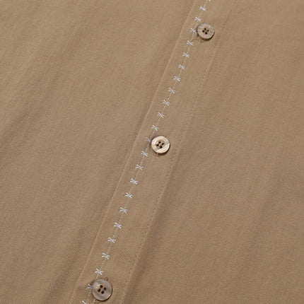 Minimal Casual Loose Short Sleeve Shirt featuring a close-up of buttons and subtle stitching on fabric.