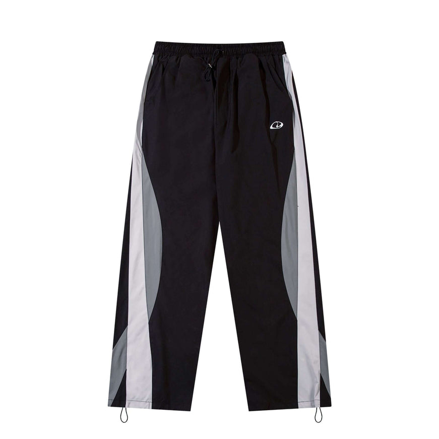 Model wearing Black paneled technical track pants by Grozavu