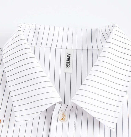 Close-up of the collar of the Flame Lace Patchwork Shirt – Loose Fit featuring striped detailing and a button.